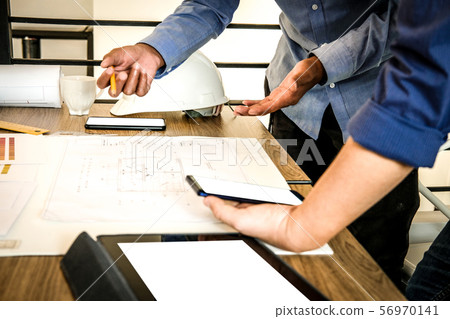 architect interior designer working with house drawing plan & color swatch 56970141