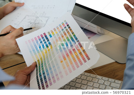 architect interior designer working with house drawing plan & color swatch 56970321