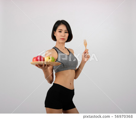 sporty fitness woman in sportswear with apple. healthy sport lifestyle 56970368