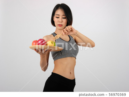 sporty fitness woman in sportswear with apple. healthy sport lifestyle sporty fitness woman in sportswear with apple. healthy sport lifestyle 56970369