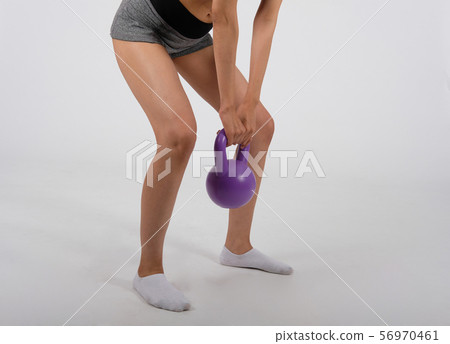 sporty woman in sportswear with kettlebell doing fitness workout on white background. healthy sport lifestyle 56970461