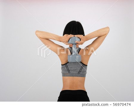 sporty woman in sportswear with dumbbell doing fitness workout on white background. healthy sport lifestyle 56970474
