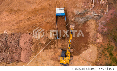 Aerial view excavator working on a construction Aerial view excavator working on a construction 56971495