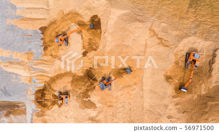 Aerial view excavator working on a construction Aerial view excavator working on a construction 56971500