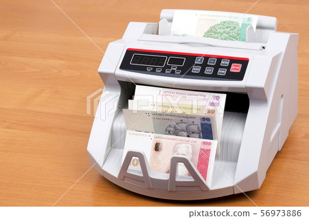 Latvian Lats in a counting machine Latvian Lats in a counting machine 56973886