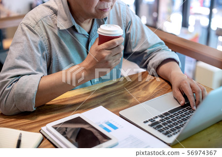 Businessman in casual style working with graph Businessman in casual style working with graph 56974367