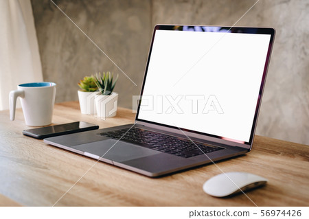 Laptop computer with blank screen on table. Laptop computer with blank screen on table. 56974426