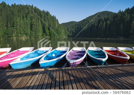 bright boats on a mountain lake 56976062