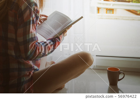 girl on a windowsill girl on a windowsill 56976422