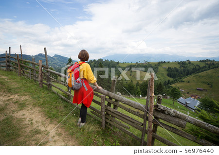 tourist girl standing at the mountains 56976440