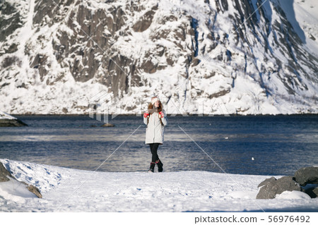 girl walks along the shore of the fjord girl walks along the shore of the fjord 56976492