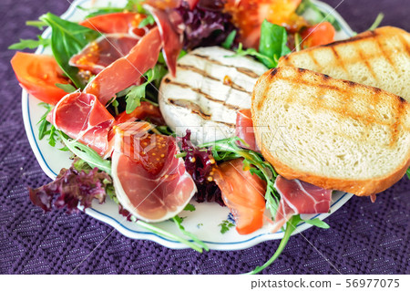 Tasty mixed salad dish with grilled camembert Tasty mixed salad dish with grilled camembert 56977075