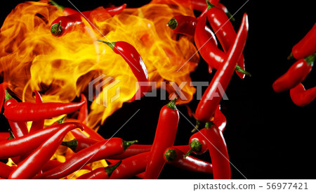 Flying red hot chilli peppers with flames 56977421