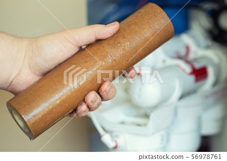 Close-up plumber hand holding used dirty rusty 56978761