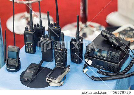 Many portable radio transceivers on table at Many portable radio transceivers on table at 56979739