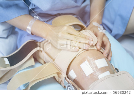 Asian woman patient with bandage compression knee 56980242