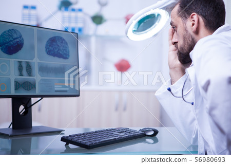 Doctor in a hospistal laboratory reading a braing x-ray 56980693