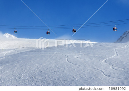 Gondola lift and off-piste ski slope in fog Gondola lift and off-piste ski slope in fog 56981992