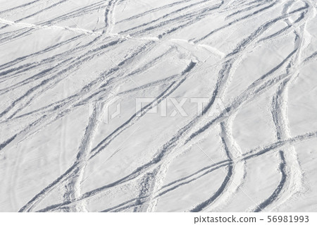 Snowy off-piste ski slope with trace from skis and Snowy off-piste ski slope with trace from skis and 56981993