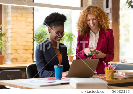 Interior designer smiling while working together on one project 56982355