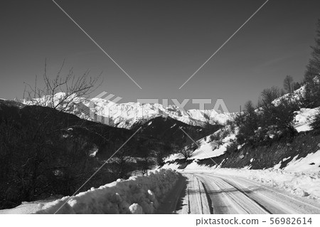 Ice-covered road in winter snow mountain at sun Ice-covered road in winter snow mountain at sun 56982614