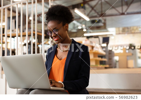 African-American office worker using laptop while working hard African-American office worker using laptop while working hard 56982623
