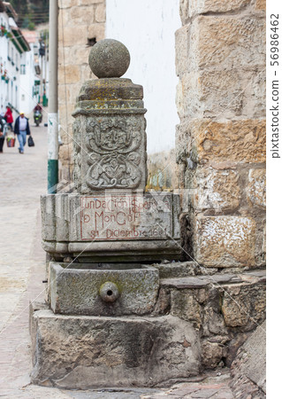 Stone fountain with date of founding of Mongui 56986462