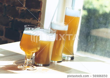 Glasses of different kinds of beer, time for oktoberfest Glasses of different kinds of beer, time for oktoberfest 56986850