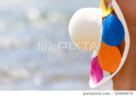 Bright colored female hat at the feet. 56986879