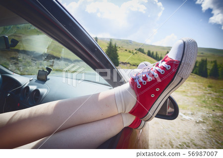 Girl legs sticking out of the car 56987007