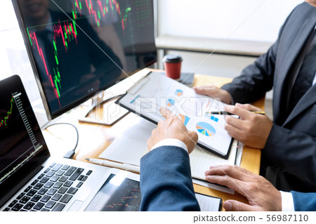 businessman sit at ther table looking at computer 56987110