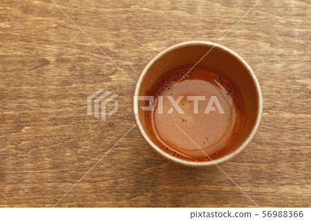 Brown paper cup of espresso coffee on wooden table 56988366
