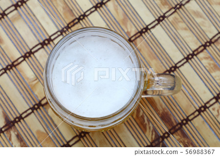 Glass mug of unfiltered weizen beer on table 56988367