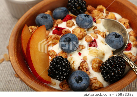 Portion of muesli granola breakfast with yogurt 56988382