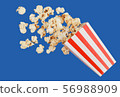 popcorn in classic red box splashing of the box , blue background with clipping path 56988909