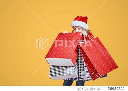 Cute girl with Christmas presents 56989521