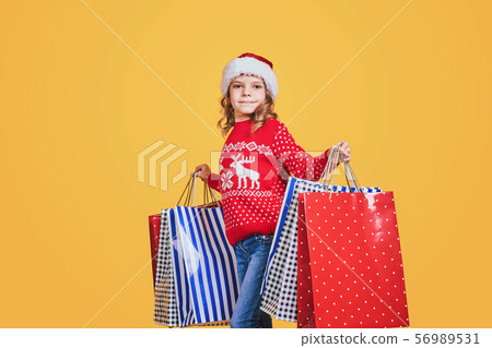 Cute girl with Christmas presents 56989531