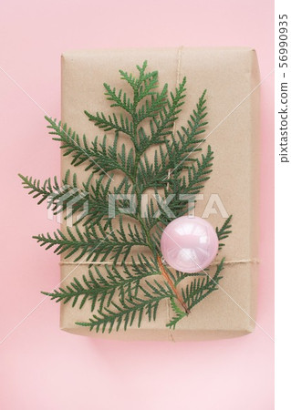 Christmas giftbox with decor on pink paper. 56990935
