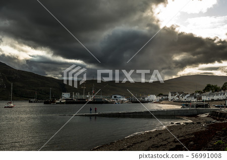 City Of Ullapool With Harbor And Boats Facing Heavy Weather At Loch Broom In Scotland City Of Ullapool With Harbor And Boats Facing Heavy Weather At Loch Broom In Scotland 56991008