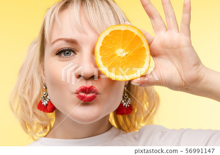 Funny fashionable girl with hairstyle holding 56991147