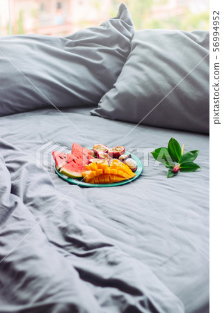 tropical fruit floers in grey bed, breakfast, tropical fruit floers in grey bed, breakfast, 56994952