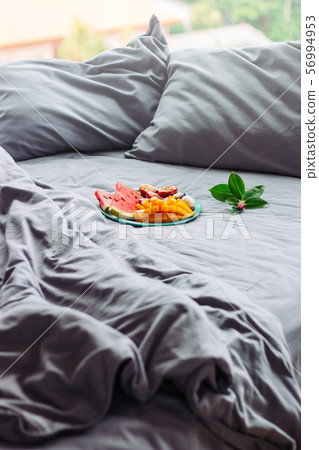 surprise tropical fruit in grey bed, relax 56994953