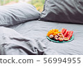 Plate with tropical fruit in grey bed, breakfast 56994955