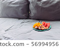 Plate with tropical fruit in grey bed, pilow 56994956
