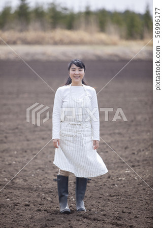 Farmer woman in spring field 56996177