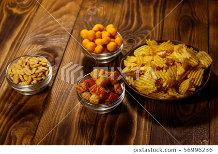 Mix of snacks for beer on wooden table Mix of snacks for beer on wooden table 56996236