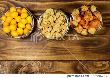 Mix of snacks for beer on wooden table Mix of snacks for beer on wooden table 56996237