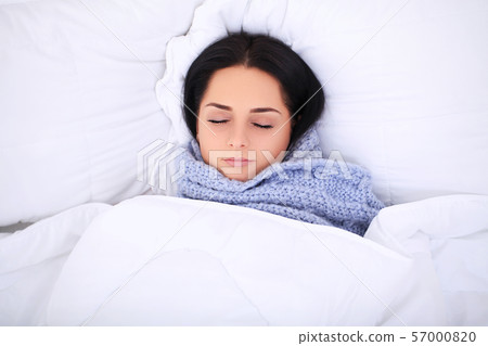 Sick young woman is coughing on the bed Sick young woman is coughing on the bed 57000820