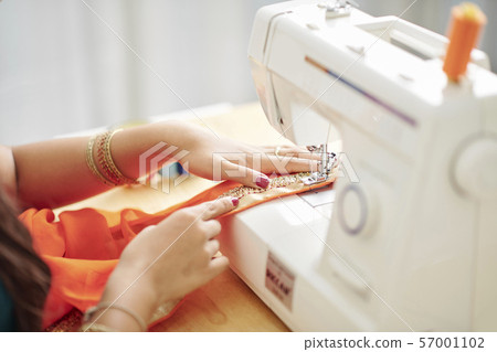 Semstress making sari dress 57001102