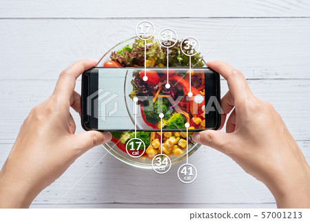 Calories counting and food control concept. woman using application on smartphone for scanning the amount of calories in the food before eat 57001213